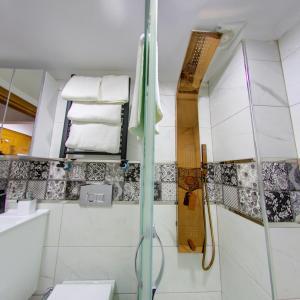 a bathroom with a shower and a toilet and towels at Denis suit apart in Istanbul