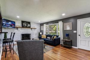 sala de estar con sofá azul y chimenea en Spacious 4BR Marietta Home, Perfect for Families, en Marietta