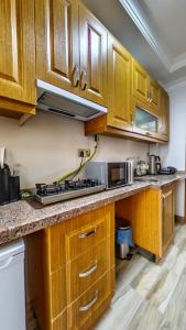 a kitchen with wooden cabinets and a stove top oven at Denis suit apart in Istanbul