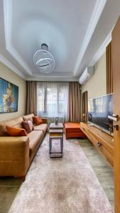 a living room with a couch and a flat screen tv at Denis suit apart in Istanbul