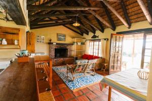 a living room with a couch and a fireplace at Rivertime in Malgas