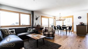 a living room with a couch and a table at Haus Golmenegg, Riederalp in Riederalp