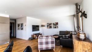 a living room with a couch and a table at Haus Golmenegg, Riederalp in Riederalp