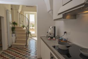 a kitchen with a sink and a counter top at Mille Lire - Family suites in Monopoli