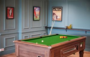 a room with a pool table with a ball at Thistle London Heathrow Terminal 5 in Hillingdon