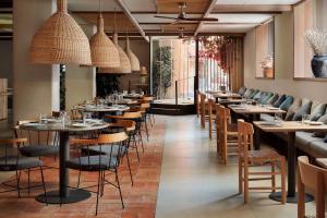 a row of tables and chairs in a restaurant at NH Madrid Zurbano in Madrid