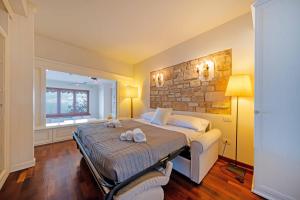 a bedroom with a bed with two towels on it at ApartmentsGarda - Residence Pasola in Brenzone sul Garda