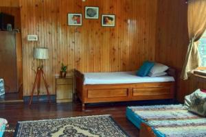 a bedroom with a bed in a wooden wall at Darjeeling CoLiving Home in Darjeeling