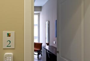 a door leading to a room with a desk and a chair at Palm Suites in Naples