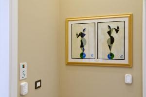 a picture hanging on a wall in a room at Palm Suites in Naples
