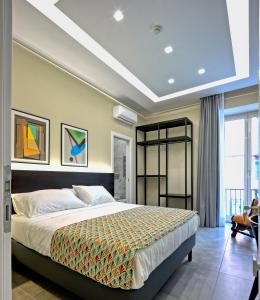 a bedroom with a bed and a large window at Palm Suites in Naples