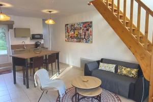 a living room with a couch and a table at Gîte le 7 de Coeur, Baie Mont St Michel in Dragey