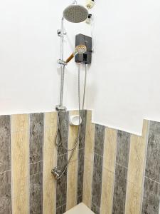 a shower with a shower head in a bathroom at Olongapo Lawud - 3mins Walking Distance to Inflatable Island and Beaches in Olongapo