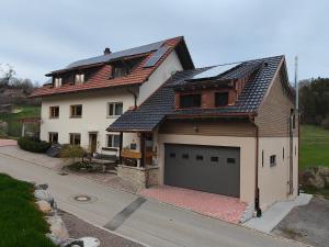 a large white house with a large garage at Thomas's Loft in Stühlingen