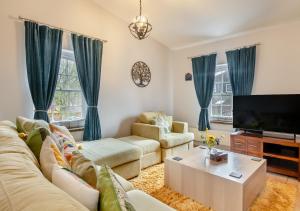 a living room with a couch and a tv at The Old Mill Cottage - Norfolk in Fakenham