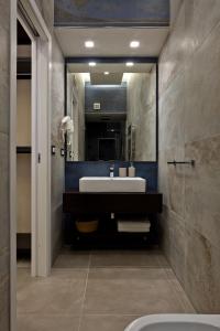 a bathroom with a sink and a mirror at Palm Suites in Naples