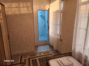a bathroom with a shower and a toilet and a mirror at Hostel Highway in Samarkand