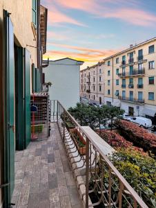 a balcony with a wooden bench and buildings at Arcadia in Verona
