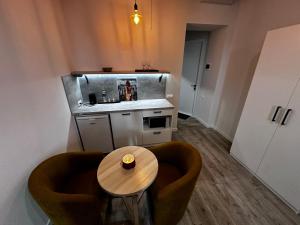 a small kitchen with a table and two chairs at Apart-HOTEL GALLERY 21 in Lviv