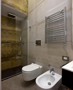 a bathroom with a toilet and a sink at Palm Suites in Naples