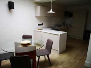 a kitchen with a glass table and some chairs at Home in Blackrock Dublin in Dublin