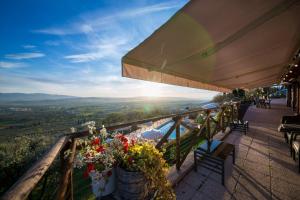 a balcony with flowers and a view of the valley at Le Terrazze di Cancellara in Foligno