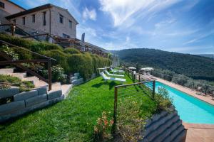 a resort with a swimming pool and a building at Le Terrazze di Cancellara in Foligno