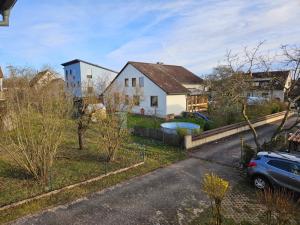 a house with a car parked in front of it at Ferienwohnung Maria 5 in Haundorf