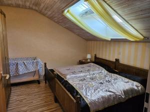 a bedroom with a bed with a window and a table at Ferienwohnung Maria 5 in Haundorf