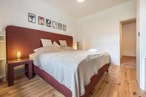 a bedroom with a large bed with a wooden headboard at Suite mit Wintergarten in Dedelstorf