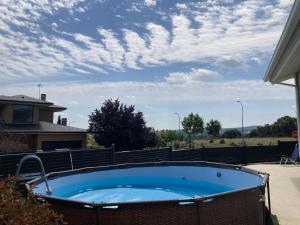 a hot tub in a yard with a cloudy sky at Casa Nunki in Guadalix de la Sierra