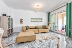 a living room with a couch and a table at 200m from the beach Apartment San Pedro Marbella in Marbella