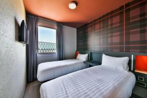 Ένα ή περισσότερα κρεβάτια σε δωμάτιο στο easyHotel Paris Charles de Gaulle Villepinte +30 φωτογραφίες