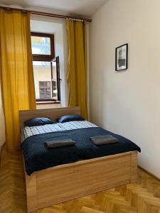a bedroom with a bed with a window at Heart of Old Town / Floriańska 19 in Krakow