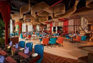 a restaurant with tables and chairs in a room at Best View Panorama Condotel managed by MLB in Nha Trang