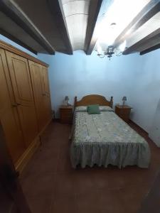 Un dormitorio con una cama y dos mesitas de noche. en Los artesanos de Andrea, en Casas del Cerro