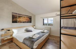 a bedroom with a large bed and two windows at Tenuta Dorata in Ragusa