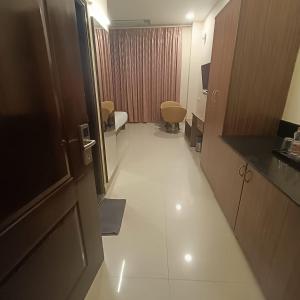 a hotel room with a corridor with a white floor at ASTRA HOTELS & SUITES WHITEFIELD NEAR TO NALLURAHALLI METRO STATION and KTPO in Bangalore