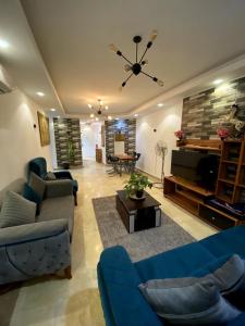 a living room with a blue couch and a table at شقة فندقية 108 in Cairo