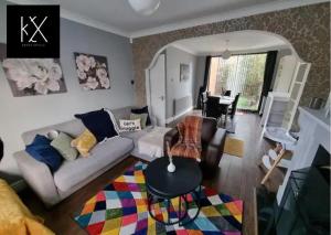 a living room with a couch and a table at Perfect for Long Stays Business & Family Guests In Droylsden ,Sleeps 6! in Manchester
