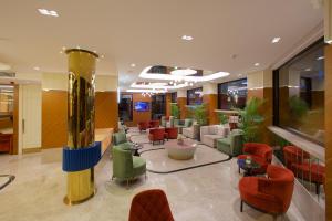a lobby with a waiting area with chairs and tables at Hotel Eyfel in Istanbul