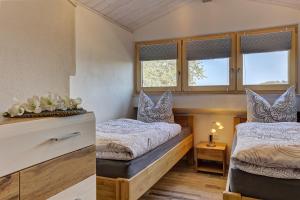 a bedroom with two beds and a window at Landhaus Melch in Zwiesel