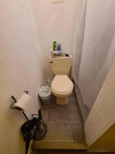 a small bathroom with a toilet and a bike at La Perla Suite in San Juan