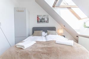 a bedroom with a bed in a attic at 10-Min Walk to Hauptbahnhof, Cozy Private Rooms with AC, TV & WIFI in Vienna