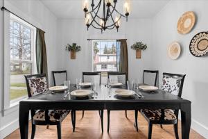 uma sala de jantar com uma mesa preta e cadeiras em The Birch House em Coeur d'Alene