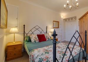 a bedroom with a bed and a lamp on a night stand at South Flat in Wells next the Sea