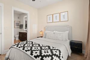 a bedroom with a bed with a black and white blanket at Luxurious Urban Retreat with Amazing Amenities in Tampa