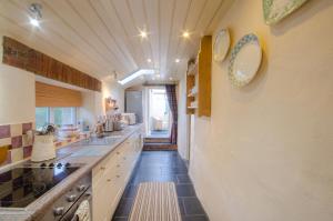 a kitchen with a sink and a counter top at Tal y Gaer Cottage Goodwick in Saint Nicholas