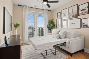 a living room with a white couch and a window at Luxurious Urban Retreat with Amazing Amenities in Tampa