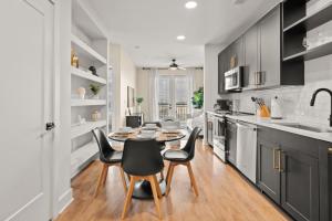 a kitchen with a dining room table and chairs at Luxurious Urban Retreat with Amazing Amenities in Tampa